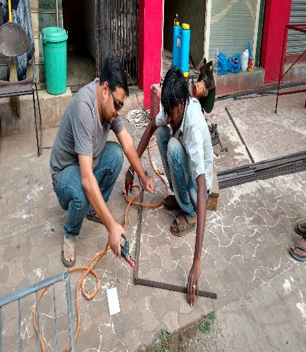 Beneficiary learning welding and electrical skills